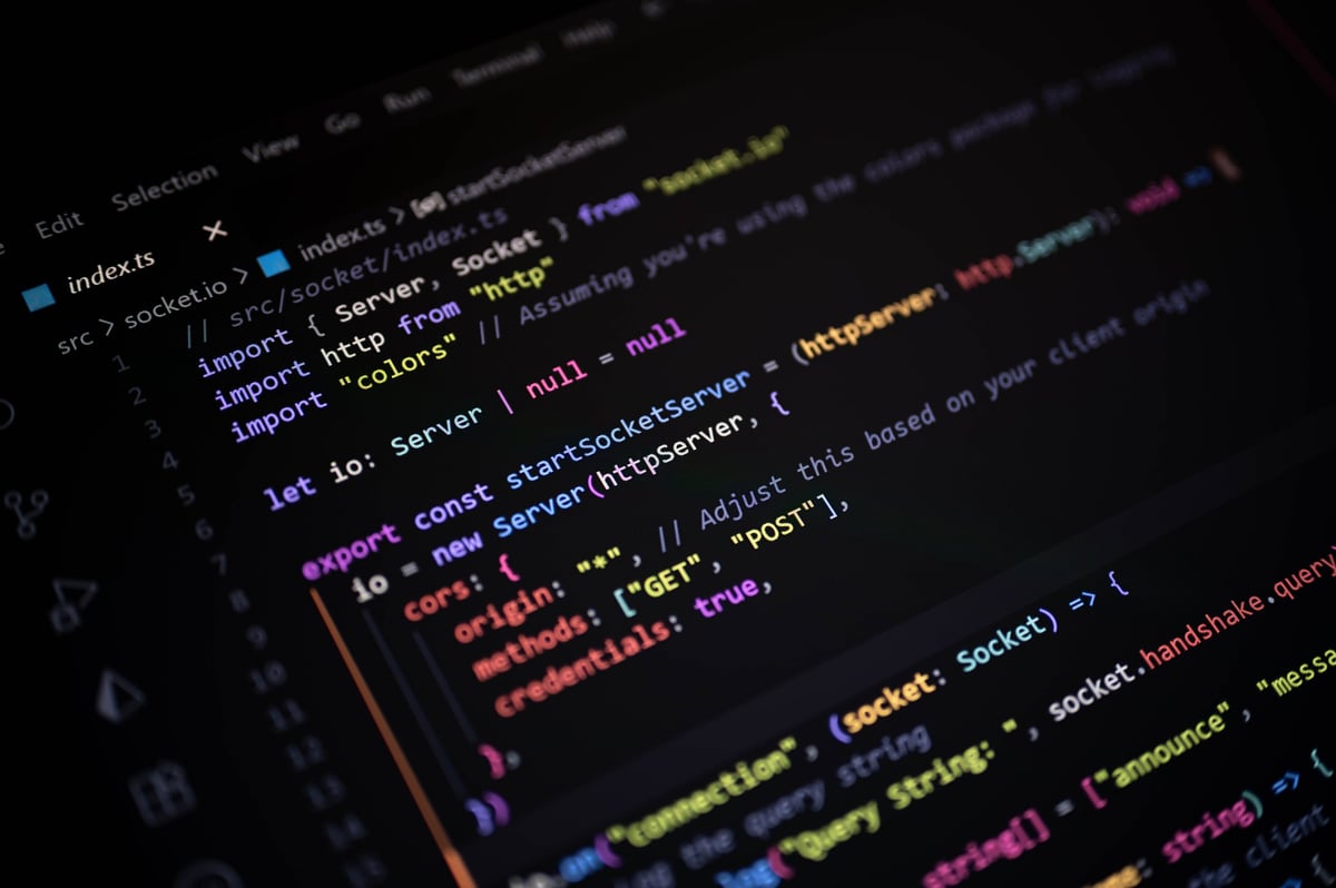 Close-up of colorful TypeScript code on a dark screen, showcasing modern backend development, socket programming, and real-time server technology in web applications.